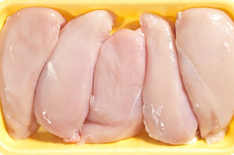 Photo of raw chicken breasts.