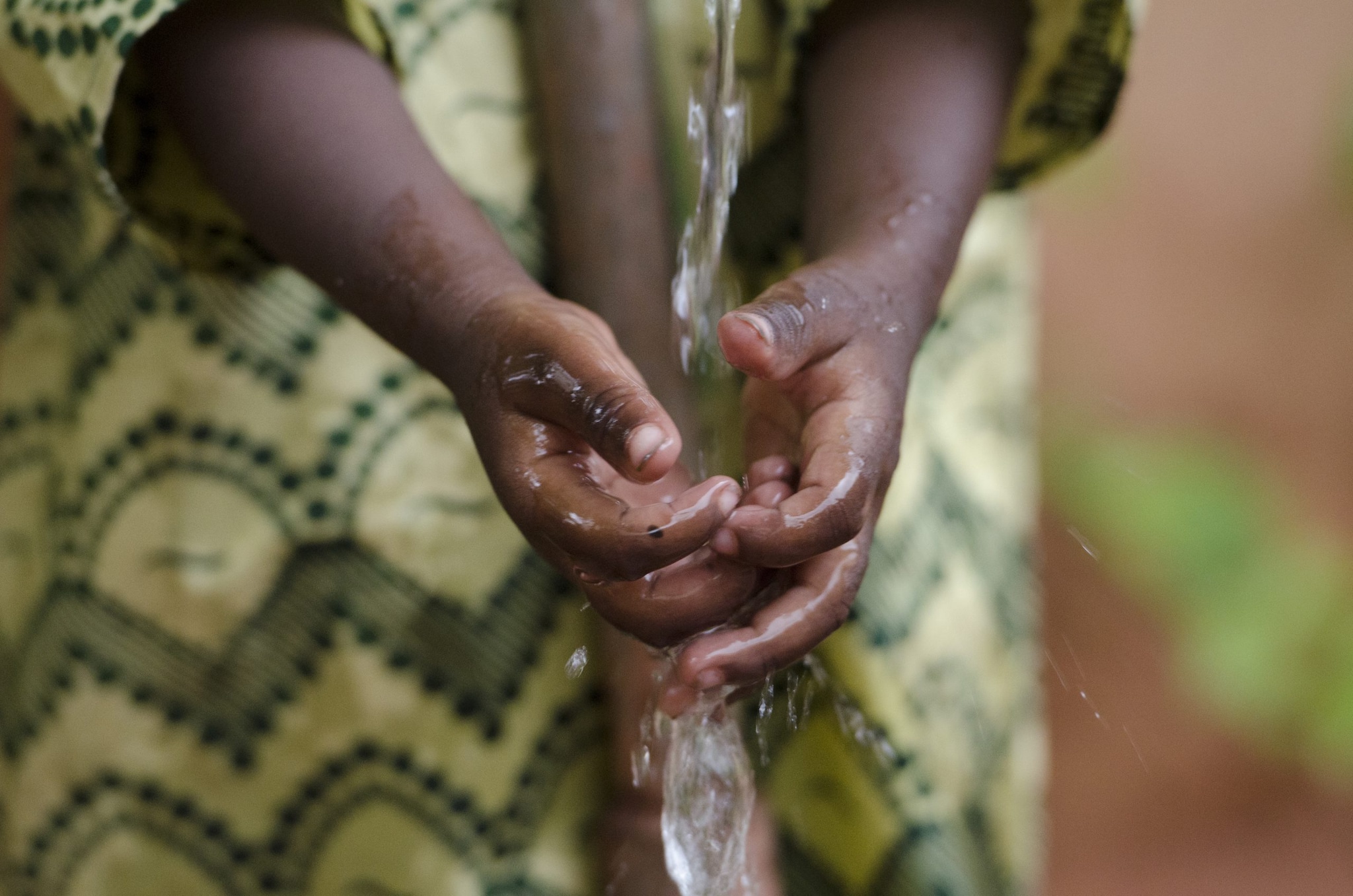 African Child washing her hands outdoors