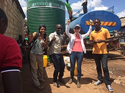 CDC team cheering the arrival of chlorinated water during a cholera outbreak after a day of finding only empty tanks.