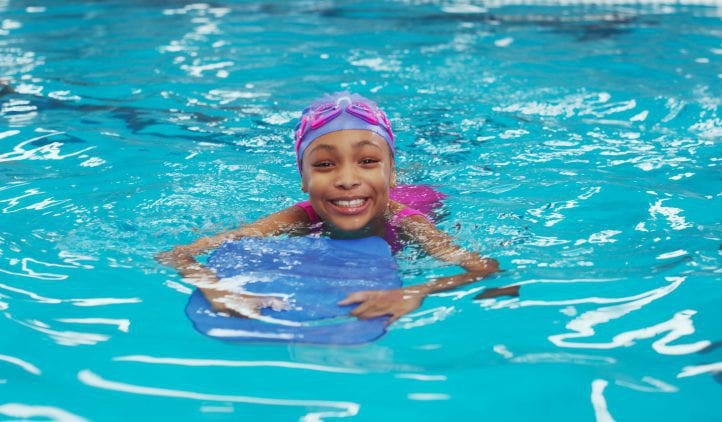 Girl learning to swim in pool