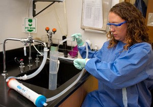 Woman in lab doing water sampling usingu ltrafiltration