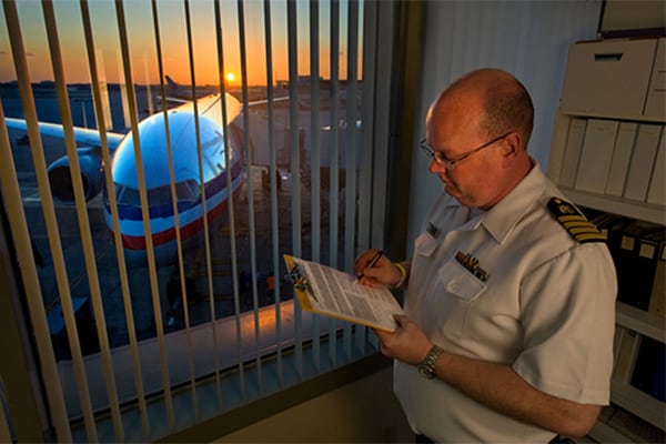  Quarantine officer at an airport reviewing data collected from an airline contact investigation. Image courtesy Greg Knobloch.