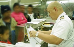 A quarantine officer processing paperwork.