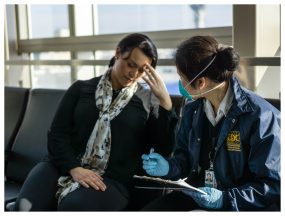 A CDC public health officer responds to a sick international traveler who just arrived in Los Angeles. Photo credit to Kenta Ishii, CDC.
