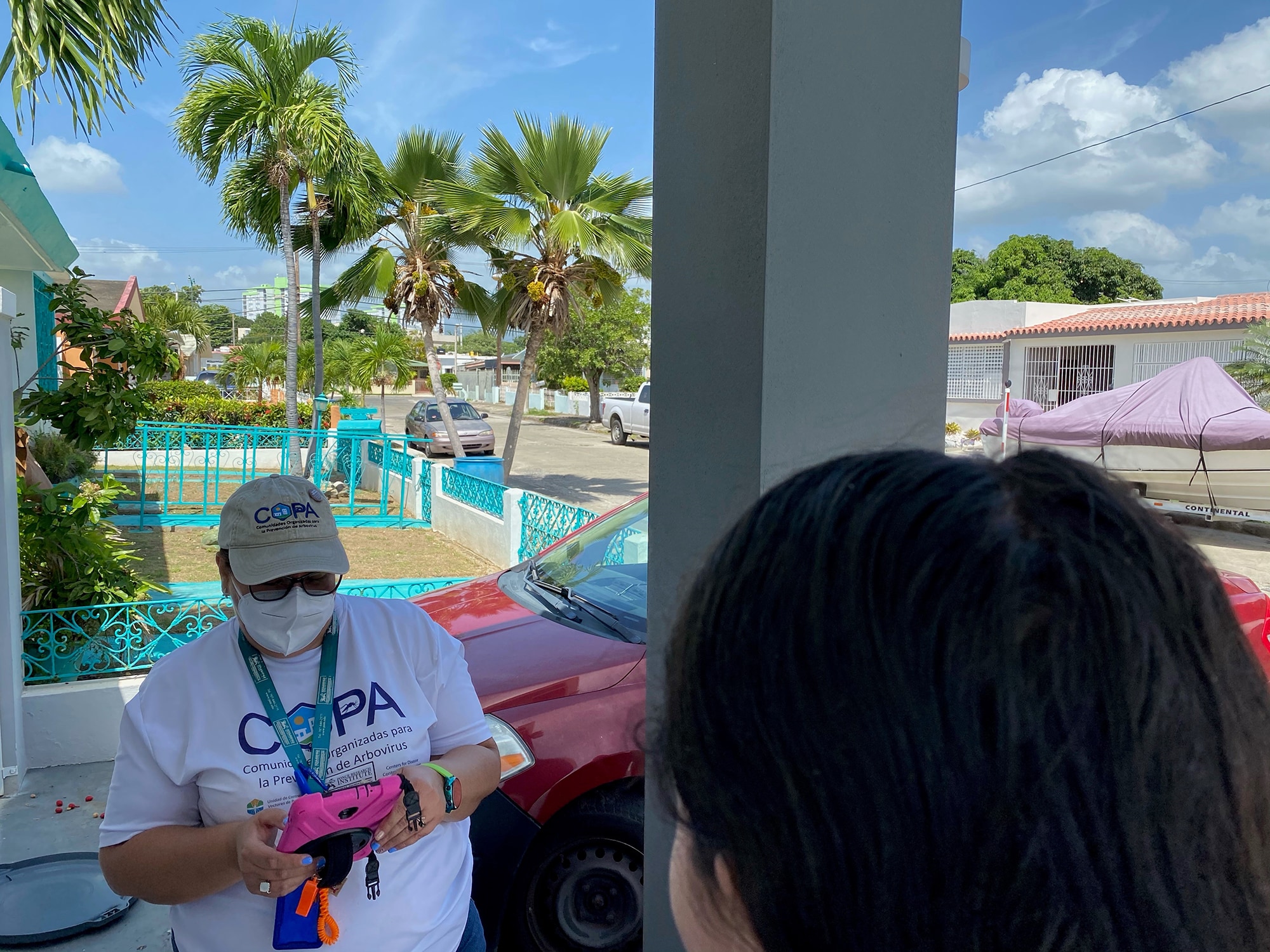 A COPA staff member uses HTrack on a mobile device to record data during a home visit in Ponce, Puerto Rico.