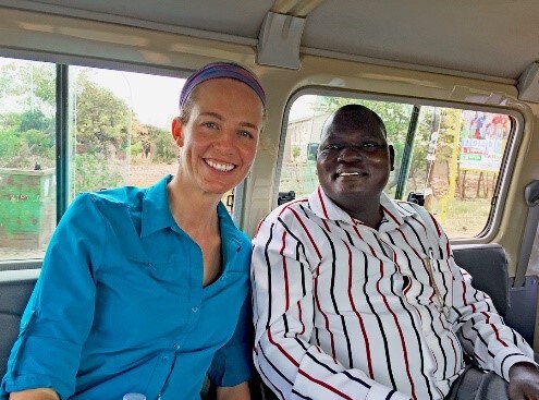 Two persons on a bus in Uganda.