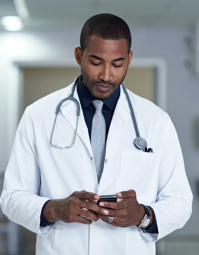 Caring is his calling as a male doctor holding a phone