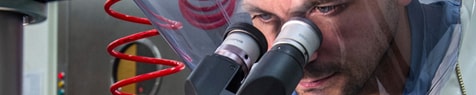 A man looking through a microscope
