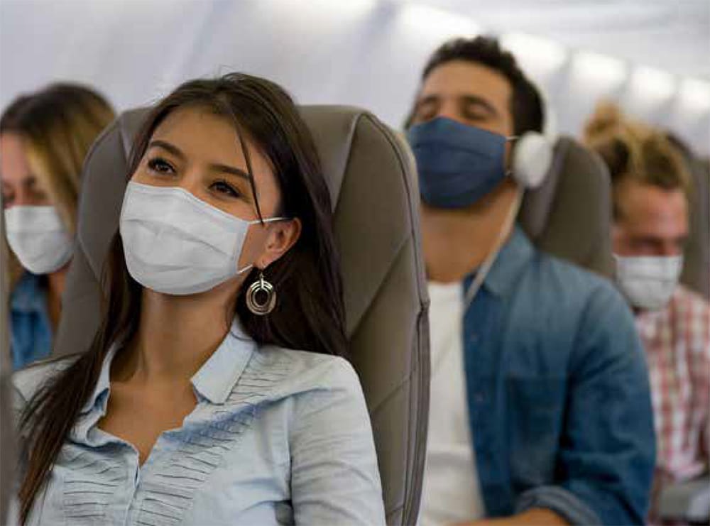 A group of plane travelers wearing masks