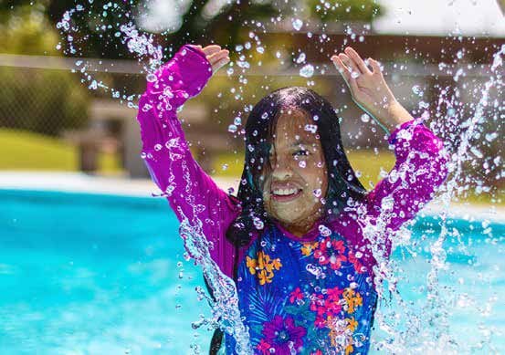 Two Young Hispanic Girls Playing in Swimming Pool in Summer Time Fun Photo Series