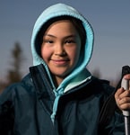 Picture of smiling young woman in winter weather clothes