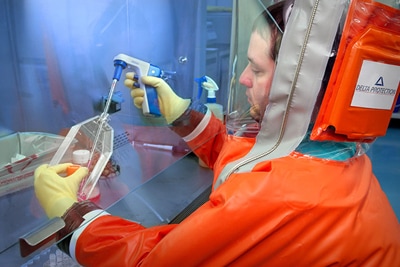 lab man in orange biohazard suit