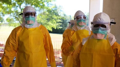 Three health workers in personal protective equipment