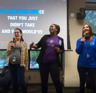 A group of NCHHSTP employees taking part in a karaoke celebration.