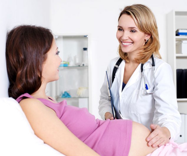 A pregnant woman meets with her health care provider for a check-up