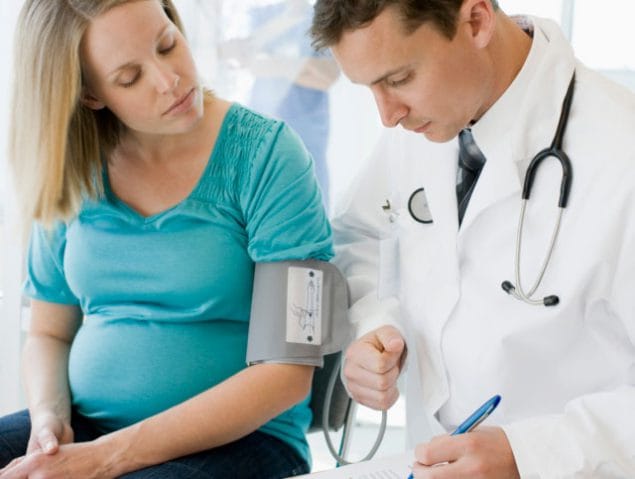A pregnant woman visits with her health care provider