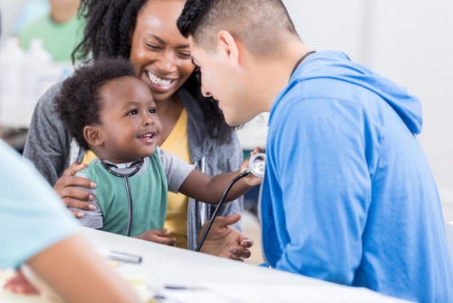 Image of child with parent and doctor