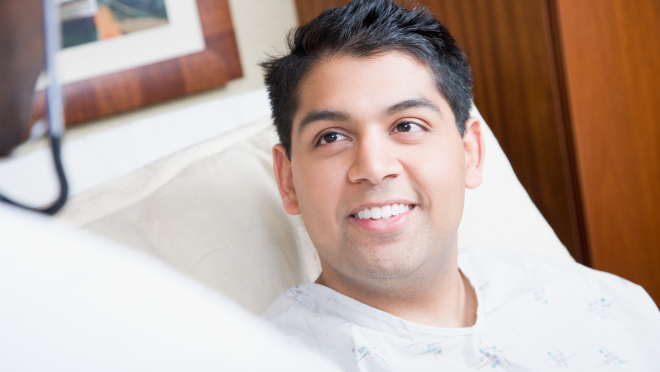Man smiling and talking to a care provider.