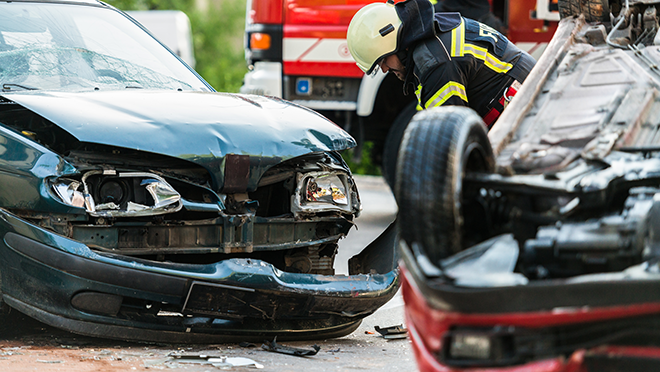 Motor vehicle crash with one vehicle flipped over and the other with front end damage. Fire rescue at the scene.