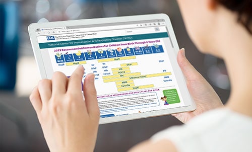 Woman viewing vaccine schedules on a tablet