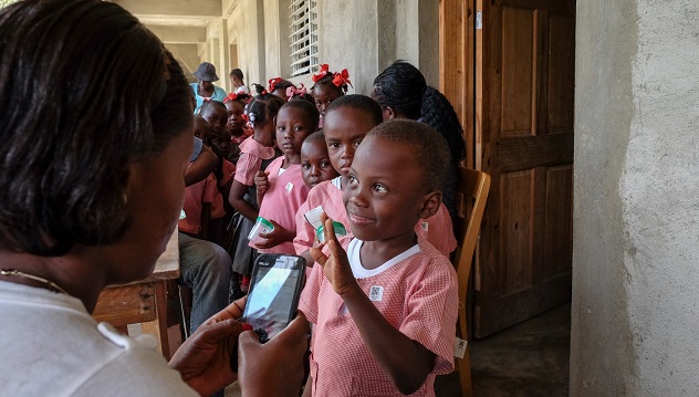 Students wait in line to be registered for an integrated LF/STH pre-TAS in Borgne Commune, Haiti.