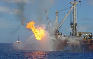 a picture of a burning oil vessel at sea