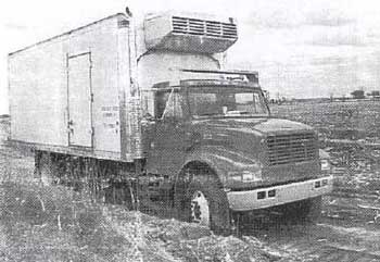 straight side produce truck partially loaded