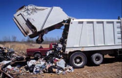 Photo 4. The compactor in the upright position, emptying its contents onto the ground.