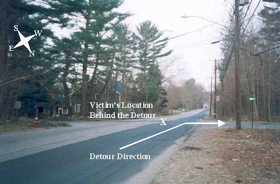 photo shows the road from the perspective of a motorist traveling west.  The arrow indicates the detour direction