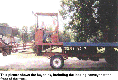 image shows the  hay truck including the load coveyor at the front of the truck