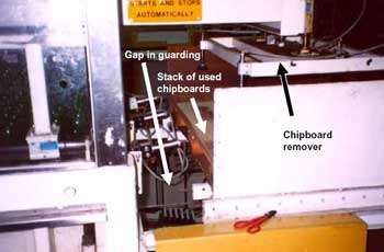 Photo 2. Gap in guarding showing chipboard remover.