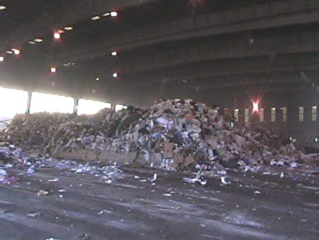 Exhibit #2. View from inside transfer station looking north at dumped waste in a designated bin.