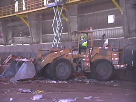 Exhibit #4. View of the left side of the front-end loader involved in the incident.