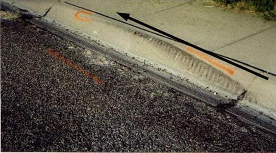 Photo 3.  These are skid marks left when the machine veered to the right, striking the concrete curb.