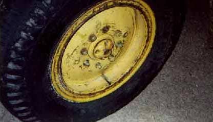 Photo 13.  Right rear-steer tire showing missing lug bolt and lug nut.