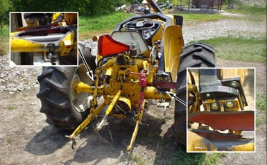 Photo 6 – Rear view of tractor with inserted photo enlargement of left and right broken axle housings.