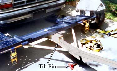 Photo 3 – Front view of tow dolly showing tilt pin removed and ramp tilted downward.