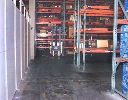 Photo 3 - View from the front of the forklift, showing the aisle ends and the wall to the side.