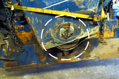 Photo 3. Damage caused by rotating drum bearing cutting through machine's sheet metal during tip-over.