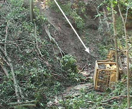 Figure 3. This photo shows the section of bank where the rollover occurred and the dozer’s final resting place.