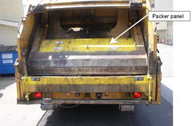 Exhibit 4. A picture of a rear loading trash truck, similar to the one involved in the incident, with the packer panel in the position when it struck the victim who was reaching into the hopper.