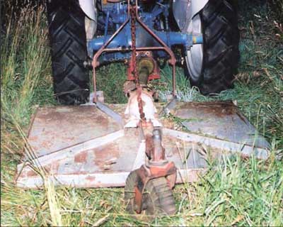 rotary cutter attached to the tractor’s three-point hitch