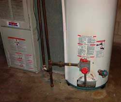 Figure 2. 40-gallon gas hot water heater warning labels near pilot light.