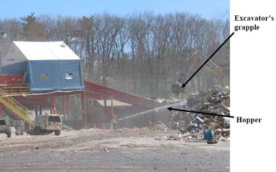 Excavator with grapple loading debris