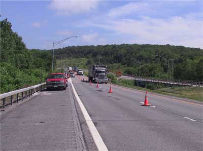 Photo 1. The site of the fatal incident where the southbound driving lane was closed to the traffic and the work zone was demarcated with orange traffic cones.