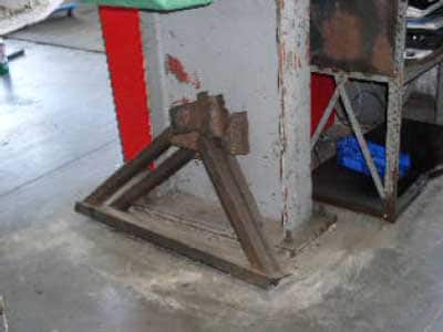Exhibit 4: A picture of the safety jack stands used to support the bed of a roll-off trash truck in the raised position.