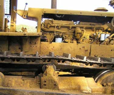 On many bulldozer models, the operator must stand on the track to access the cab.