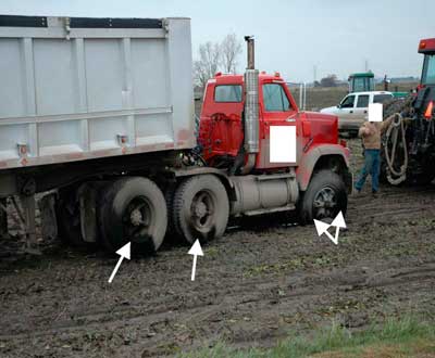 arrows point to the burn marks on the tires of the dump truck.
