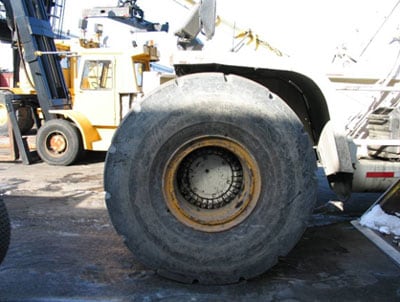 Container handler with replaced wheel.