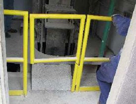 A gate guarded the manlift floor openings. At one opening, a raised plywood floor was spongy when walked upon, reducing secure footing.